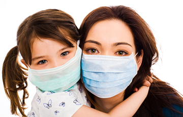 mother and daughter wearing surgical masks