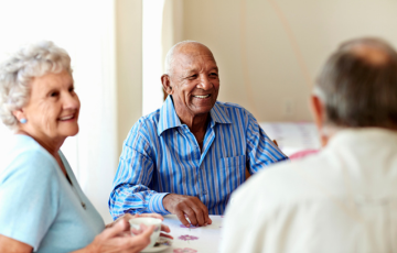 a group of seniors chatting around a table