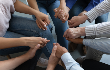 a group of people holding hands