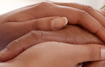 close up of two hands holding each other