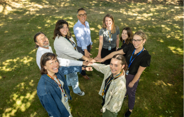 group of people holding hands in a circle