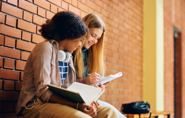 two people sitting in high school setting