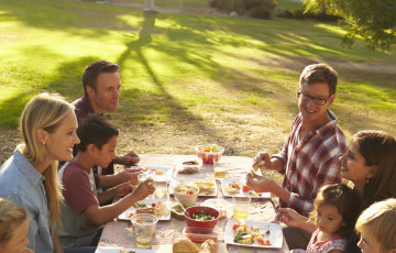 People eating lunch at a picnic bench