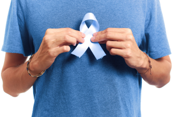 man holding Movember blue ribbon