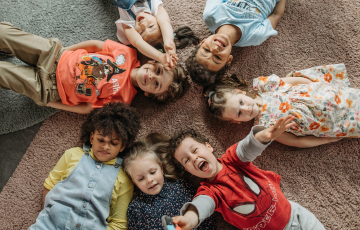 group of children lying in a circle