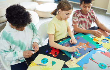 three young people doing arts and crafts